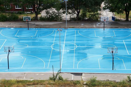 basketball court wet from the rain in a residential area, top view.