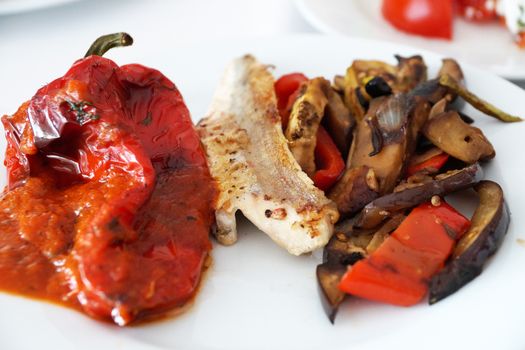 bell peppers and other grilled vegetables on a white plate.