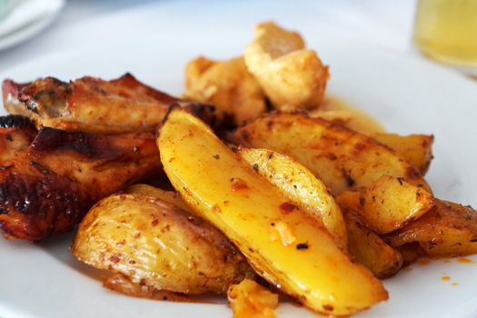 baked potatoes with meat on a white dish close up