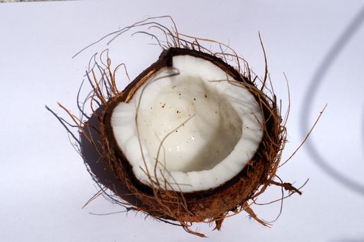 half coconut on a white background, top view.