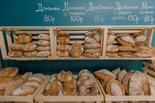 Fresh baked goods are beautifully arranged on display in wooden crates.