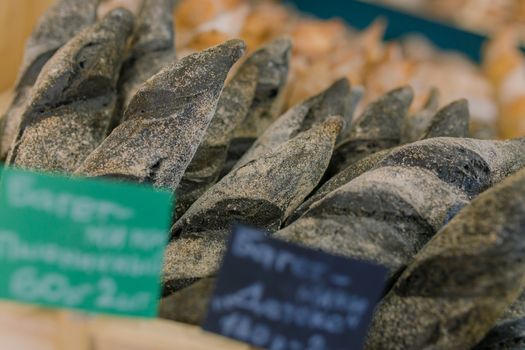 Fresh baked goods are beautifully arranged on display in wooden crates.