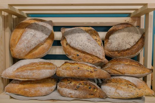 Fresh baked goods are beautifully arranged on display in wooden crates.