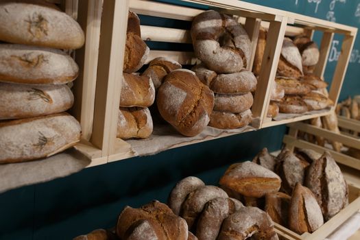 Fresh baked goods are beautifully arranged on display in wooden crates.