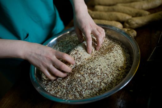 Close-up. Baker makes baked goods, shapes dough on the desktop.