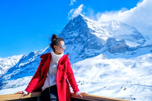 Young Woman Tourists see beautiful viewpoitn near Kleine Scheidegg station In daylight atI Switzerland