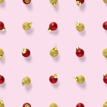 Seamless pattern with red and gold Christmas decorations on pink background. Christmas red ornaments Seamless pattern. Christmas abstract background made from balls.