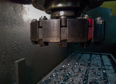 old manual milling machine shell mill in noir lighting style closeup with selective focus.