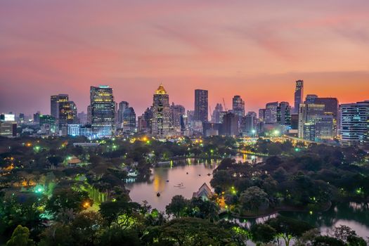 Downtown Bangkok city skyline with Lumpini park from top view in Thailand at sunset