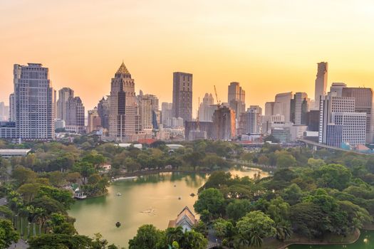 Downtown Bangkok city skyline with Lumpini park from top view in Thailand at sunset