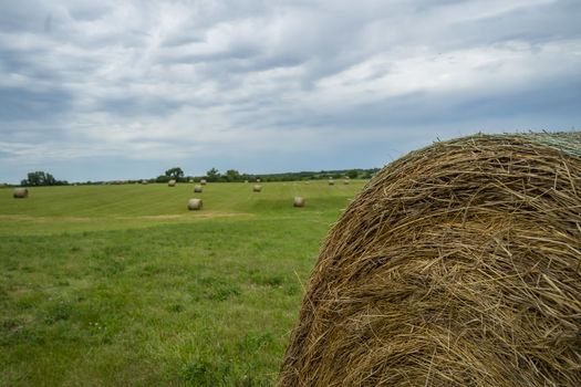 Beautiful landscape with straw bales in end of summer