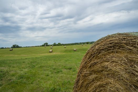 Beautiful landscape with straw bales in end of summer