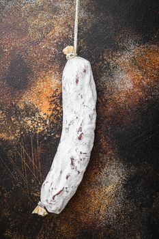 Salchichon salami sausage on old metall background.