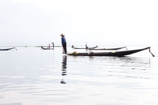 Inle Lake, Myanmar 12/16/2015 traditional Intha fisherman rowing with one leg . High quality photo