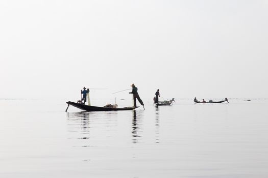 Inle Lake, Myanmar 12/16/2015 traditional Intha fisherman rowing with one leg . High quality photo