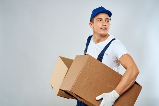 working man in uniform with boxes in his hands delivery loader lifestyle. High quality photo