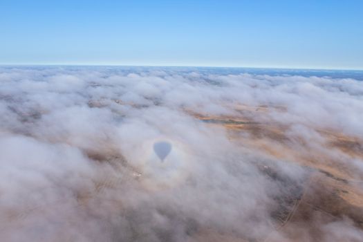 Hot air balloon in the Alentejo region, above the clouds and the fields. Portugal.