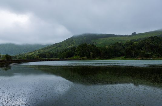 View of the Lake of Sete Cidades in the fog, a volcanic crater lake on Sao Miguel island, Azores, Portugal