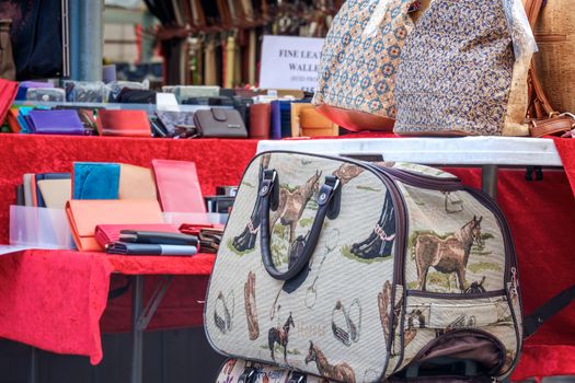 Market stall in York UK offering various bags.