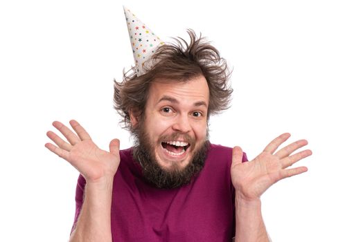 Crazy bearded Man with funny Haircut in birthday cap, isolated on white background. Happy guy screaming and keeping mouth open. Holidays, Emotions and Signs concept.