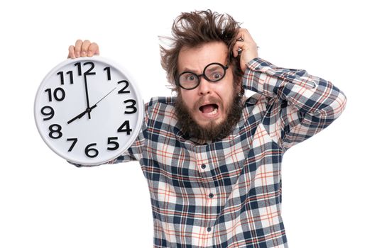 Crazy bearded Man in plaid shirt with funny Haircut in eye Glasses holding Big Clock, isolated on white background. Time concept.