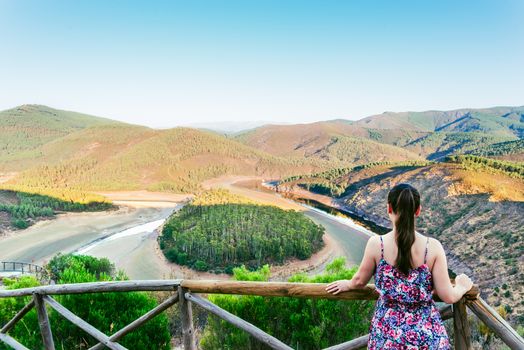 Woman looking the Meandro del Melero in Extremadura, Spain.