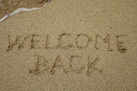 welcome back, text on sand beach, tourism after pandemic concept.