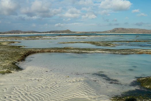 Sea during low tide creating puddles in Tanjung Aan, LOmbok, Indonesia. Small lakes between sandy islands.