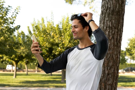 Portrait of handsome young man using his mobile phone outside