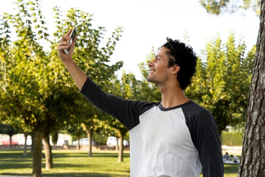 Portrait of handsome young man using his mobile phone outside