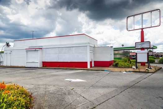 Horizontal shot of a boarded up fast food store after the Pandemic.