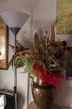 composition of dried flowers in vase with floor lamp for living room