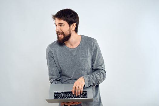 A man holding a laptop internet communication lifestyle technology light background studio. High quality photo