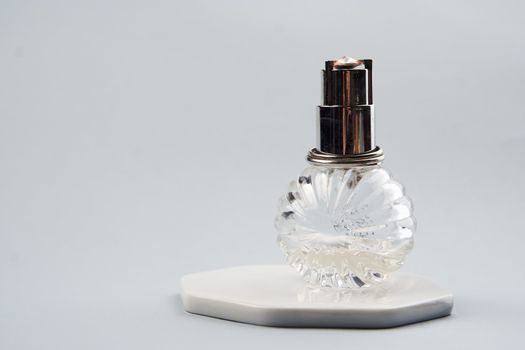 Bottle with aromatic liquid perfume cologne light background. High quality photo