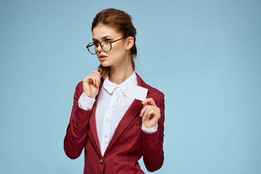 Business woman red jacket business card glasses executive blue background. High quality photo