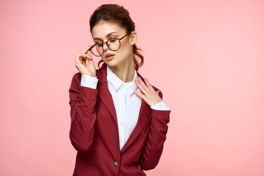 Business woman red jacket glasses executive lifestyle studio pink background. High quality photo