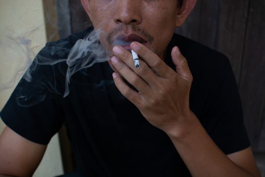 Man smoking cigarette, close-up photography