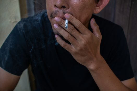 Man smoking cigarette, close-up photography