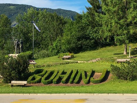 Bohinj, Slovenia, July 2017: Bohinj park with statue and hedges