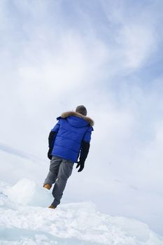 Man walking on  ice in frozen lake at Lake Bikal, Russia