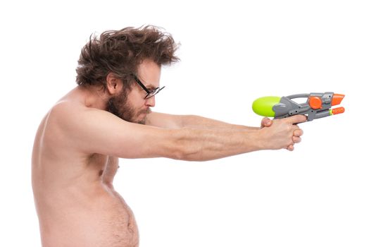 Crazy bearded Man with funny Haircut in eye Glasses, ready for fun at sunny beach. Happy and silly tourist, isolated on white background. Cheerful naked man holding Water Gun.