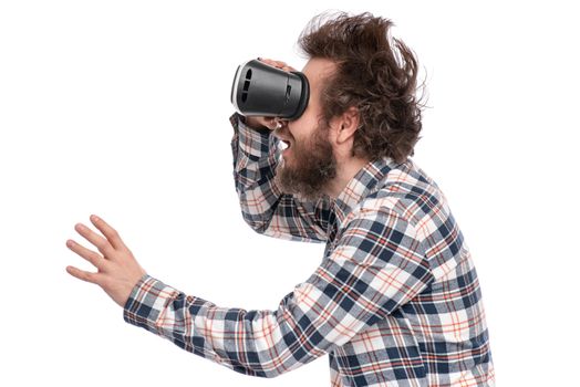 Crazy bearded Man in plaid shirt with funny Haircut wearing virtual reality helmet, isolated on white background. Portrait of funny man using VR goggles.