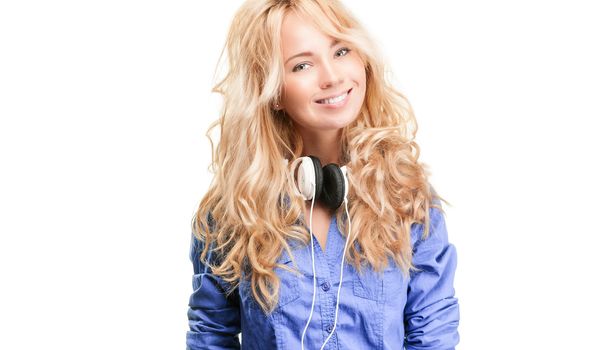 Beautiful and happy teenage girl with headphones. Smiling and looking into the camera. Isolated on white background.