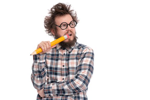 Crazy thoughtful bearded Man in plaid shirt with funny Haircut in eye Glasses holding Big Pencil - ponder and dreaming, isolated on white background.