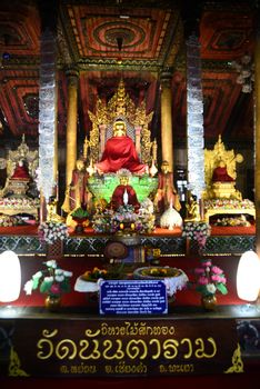 Phayao, Thailand  – 21 December, 2019 : Wat Nantaram, the principle Buddha image crafted from teak wood in the Viharn (sermon hall) of teak wood, exquisitely crafted in traditional Tai Yai style 