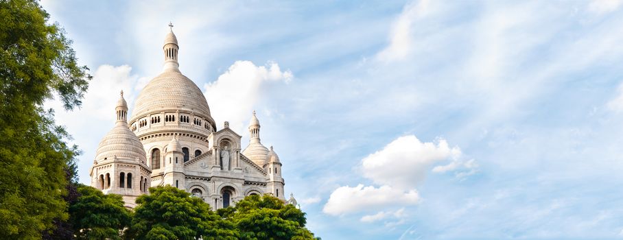 Panoramic view of Basilica of the Sacred Heart of Paris with blue cloudy sky in background (Paris, France, Europe).