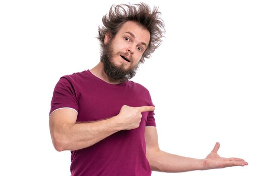 Crazy bearded Man with funny Haircut smiling and showing something on empty palm of his hand. Happy guy isolated on white background. Emotions, business, advertising and signs concept.