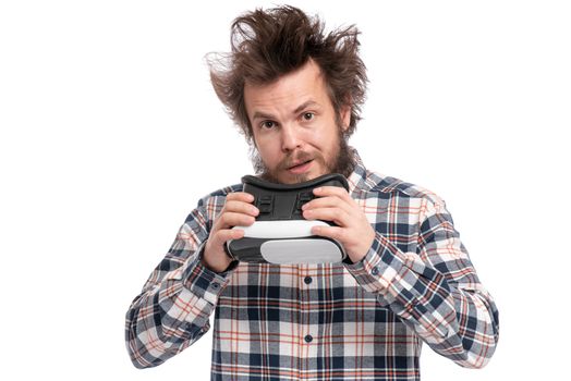 Crazy bearded Man in plaid shirt with funny Haircut wearing virtual reality helmet, isolated on white background. Portrait of funny man using VR goggles.