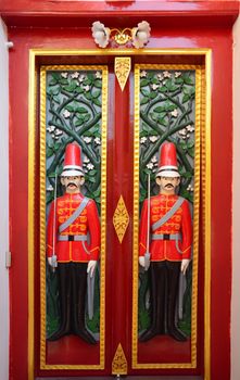 Beautiful solder carving doors ,The front door entrance with an image of watchman, public place at Wat Ratchabophit