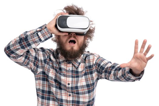 Crazy bearded Man in plaid shirt with funny Haircut wearing virtual reality helmet, isolated on white background. Portrait of funny man using VR goggles.